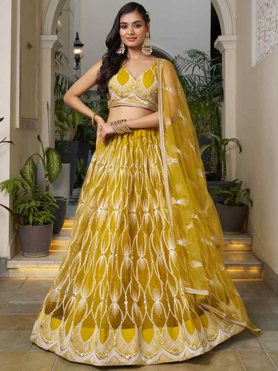 Mustard Butterfly Net Embroidery Reception Party Wear Heavy Border Lehenga Choli