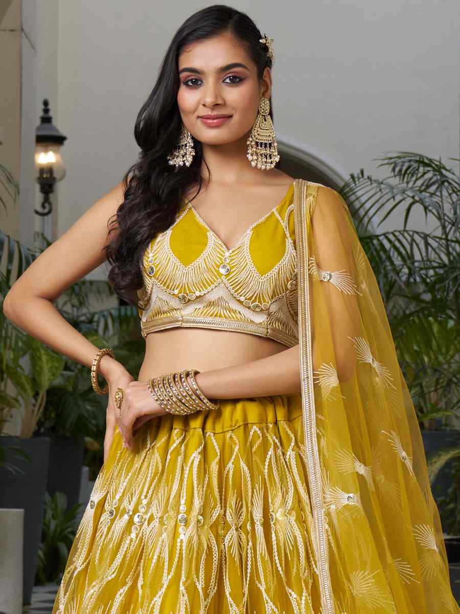 Mustard Butterfly Net Embroidery Reception Party Wear Heavy Border Lehenga Choli