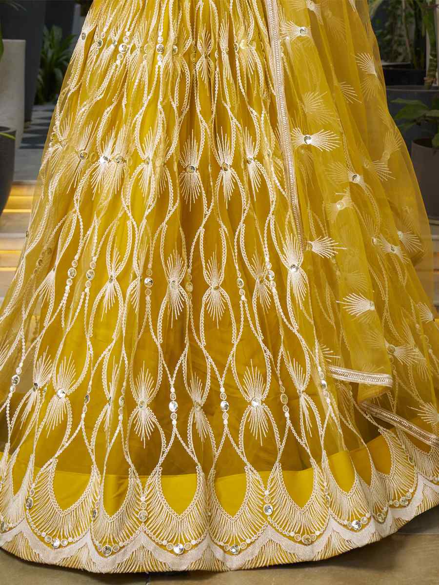 Mustard Butterfly Net Embroidery Reception Party Wear Heavy Border Lehenga Choli