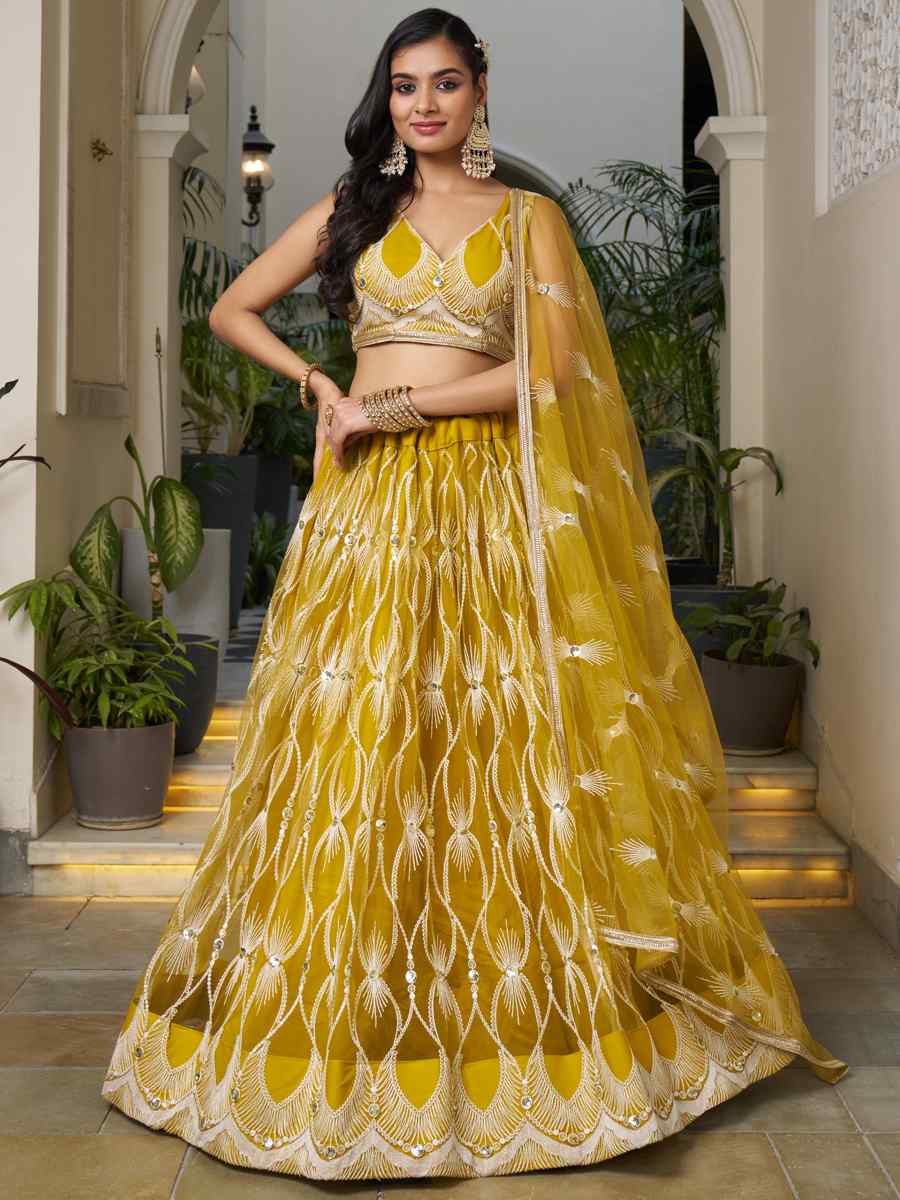 Mustard Butterfly Net Embroidery Reception Party Wear Heavy Border Lehenga Choli