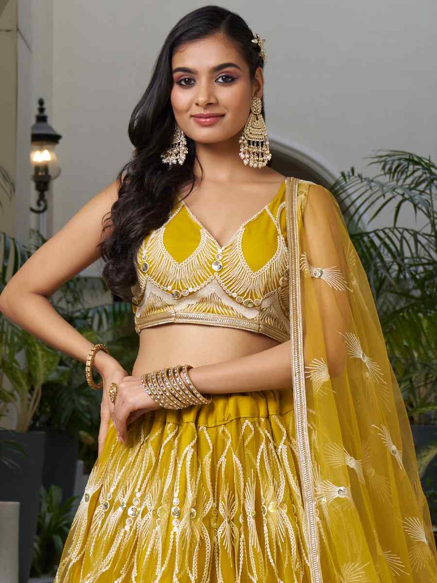 Mustard Butterfly Net Embroidery Reception Party Wear Heavy Border Lehenga Choli