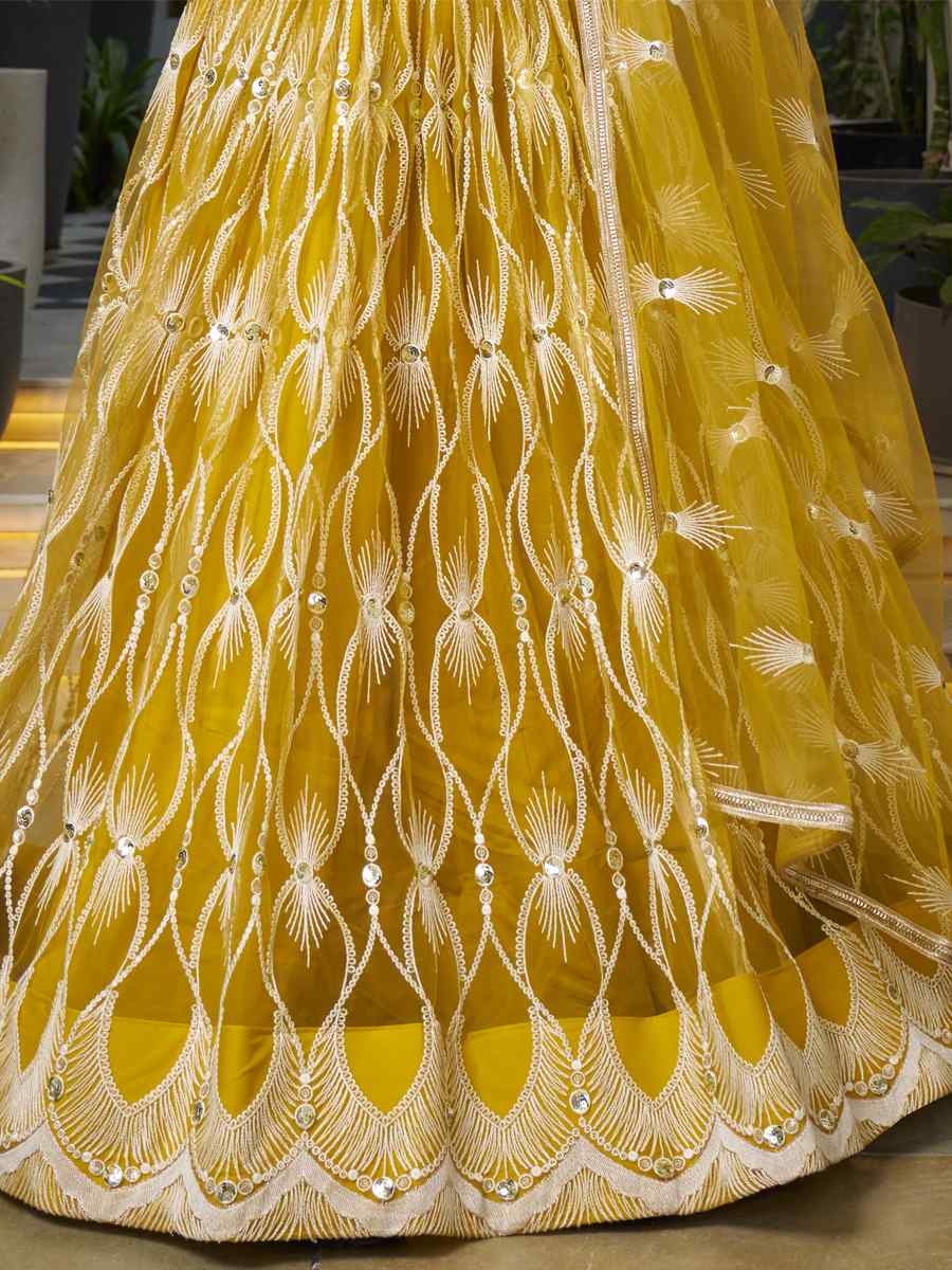 Mustard Butterfly Net Embroidery Reception Party Wear Heavy Border Lehenga Choli